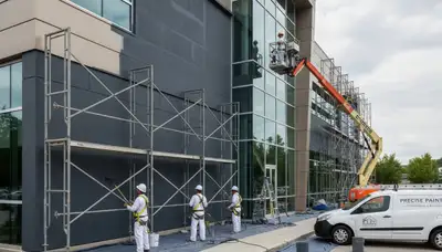 Professional commercial painters in Jacksonville FL applying weather-resistant coatings to business exterior